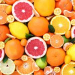 Colorful bright background of fresh ripe sweet citrus fruits: orange and red grapefruit, green lime and yellow lemon, tangerine and kumquat